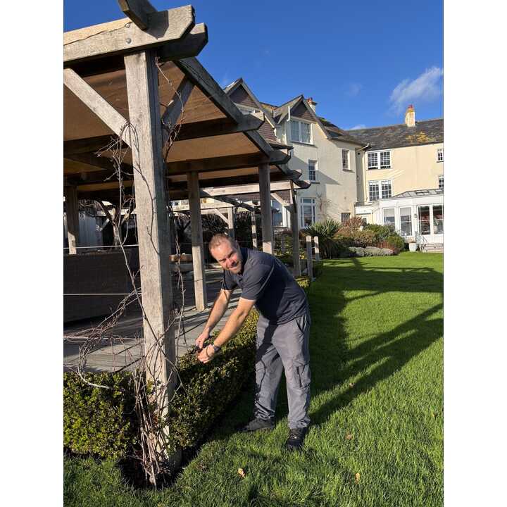 Gardener at the Alexandra works on the hedgerows