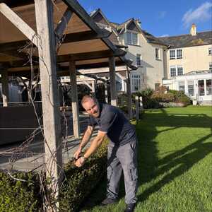Gardener at the Alexandra works on the hedgerows