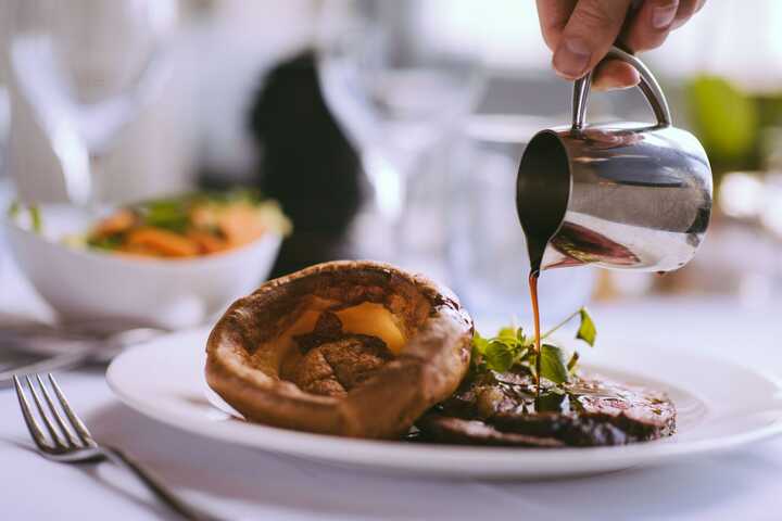 Gravy being poured on a Sunday Lunch