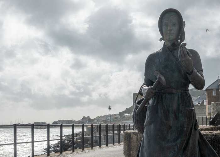 Mary Anning fossil hunting statue Lyme Regis Mary Anning fossil hunting statue Lyme Regis